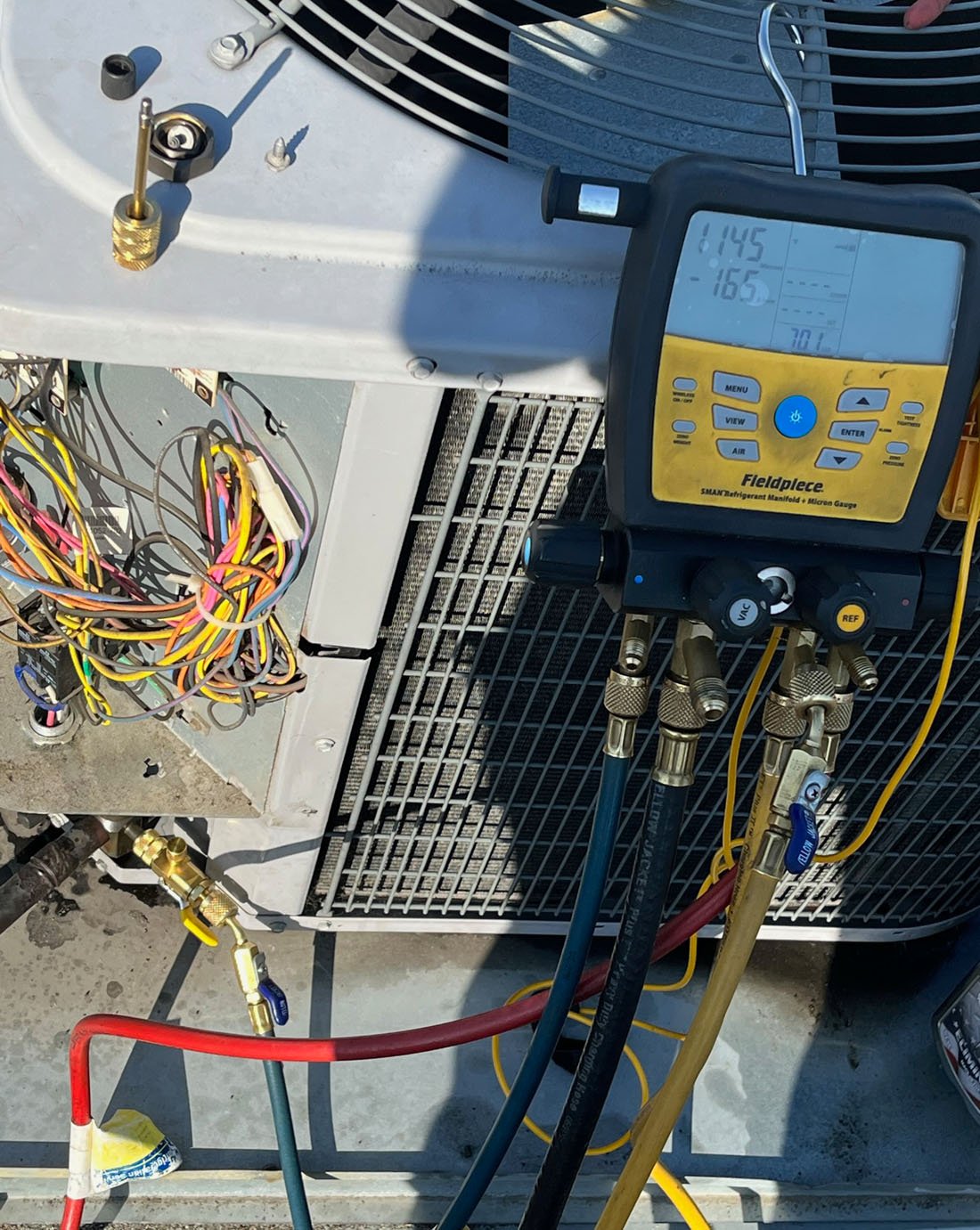 Menini HVAC repair technician on the job